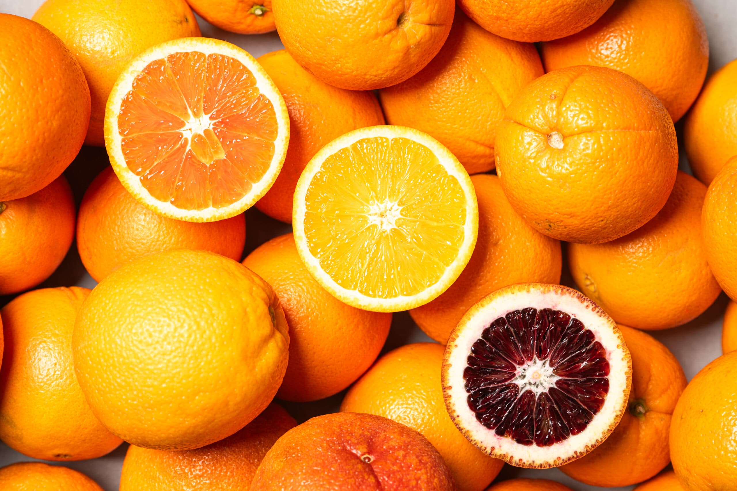 Citrus sliced in half to show many different hues