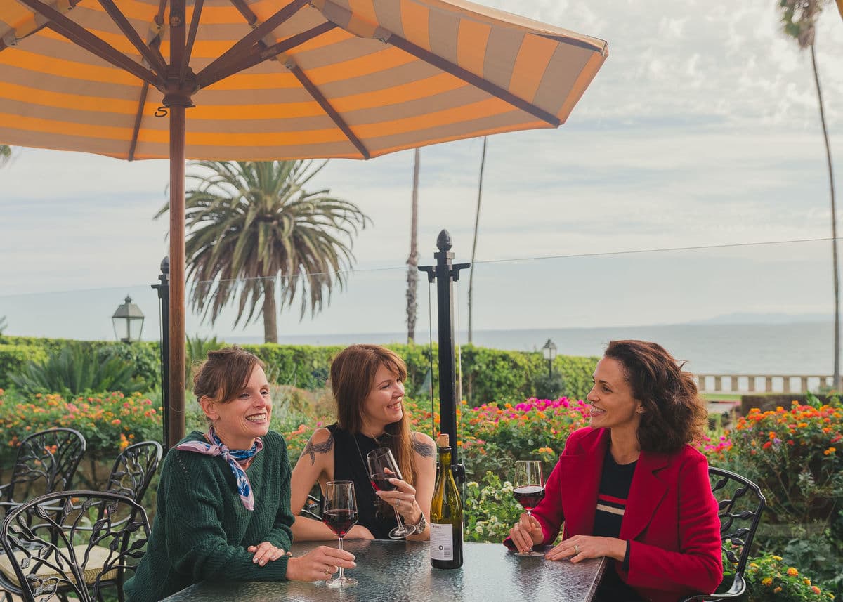 women enjoying a glass of red wine outdoors
