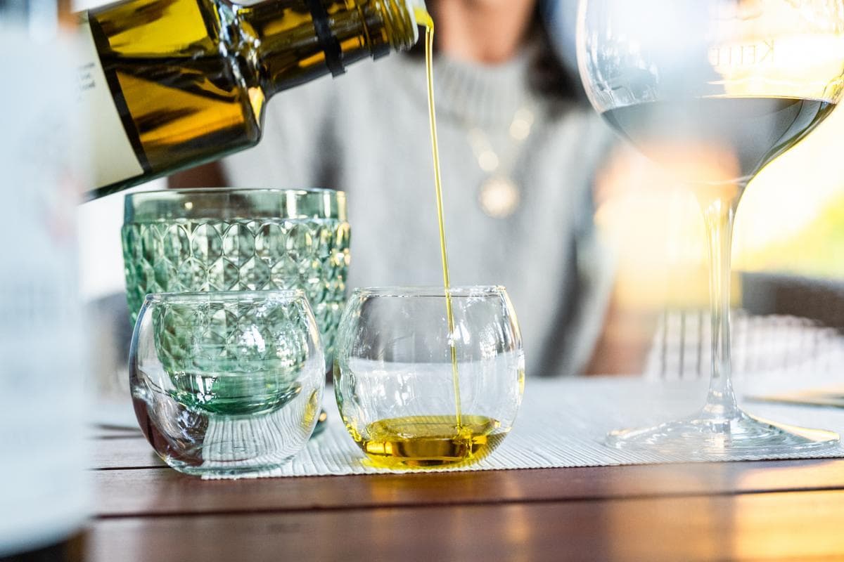 pouring olive oil into tasting glass
