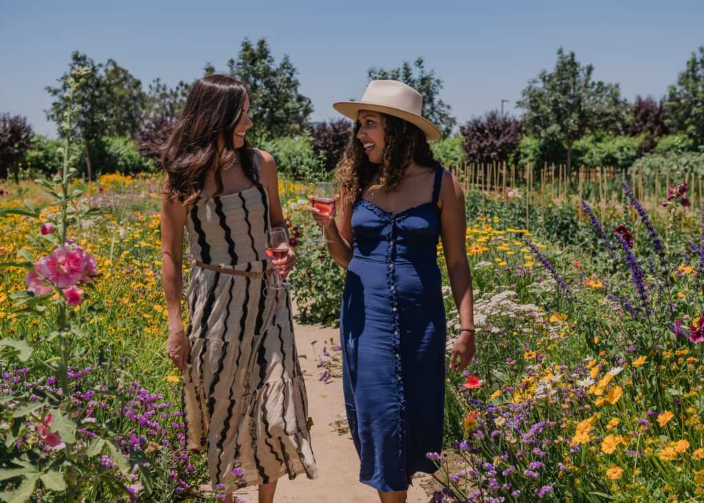two women strolling through the pollinator garden at Michael David winery in Lodi