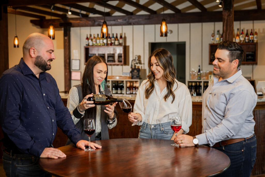 woman pouring a drink for a group at the San Joaquin Wine Co. Tasting Room 