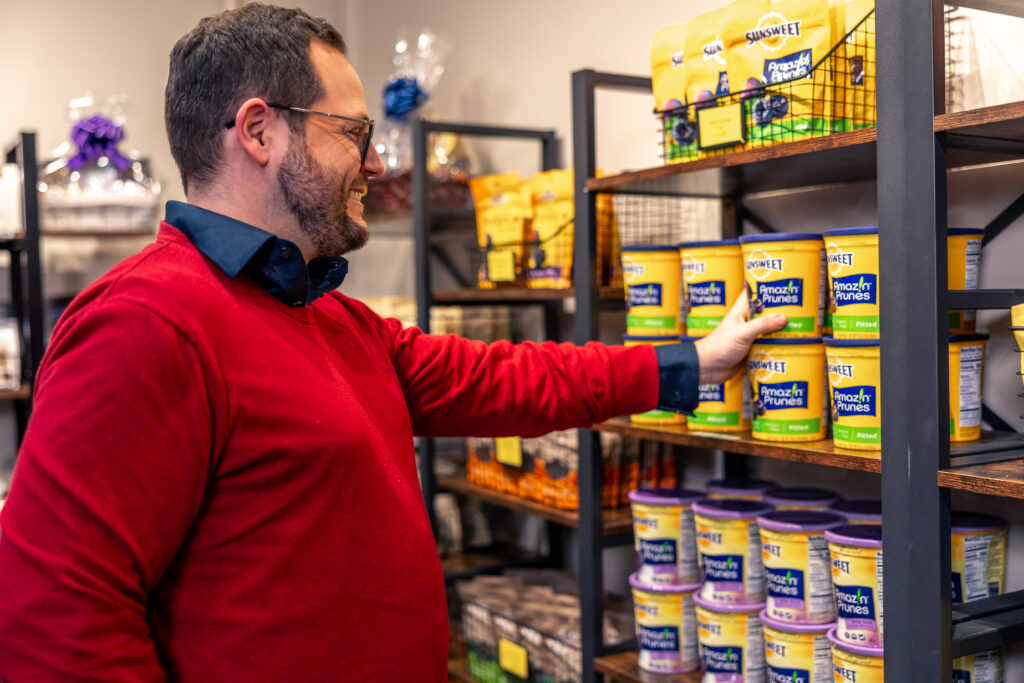 man checking out the selection of prunes and more at the Sunsweet Growers Store