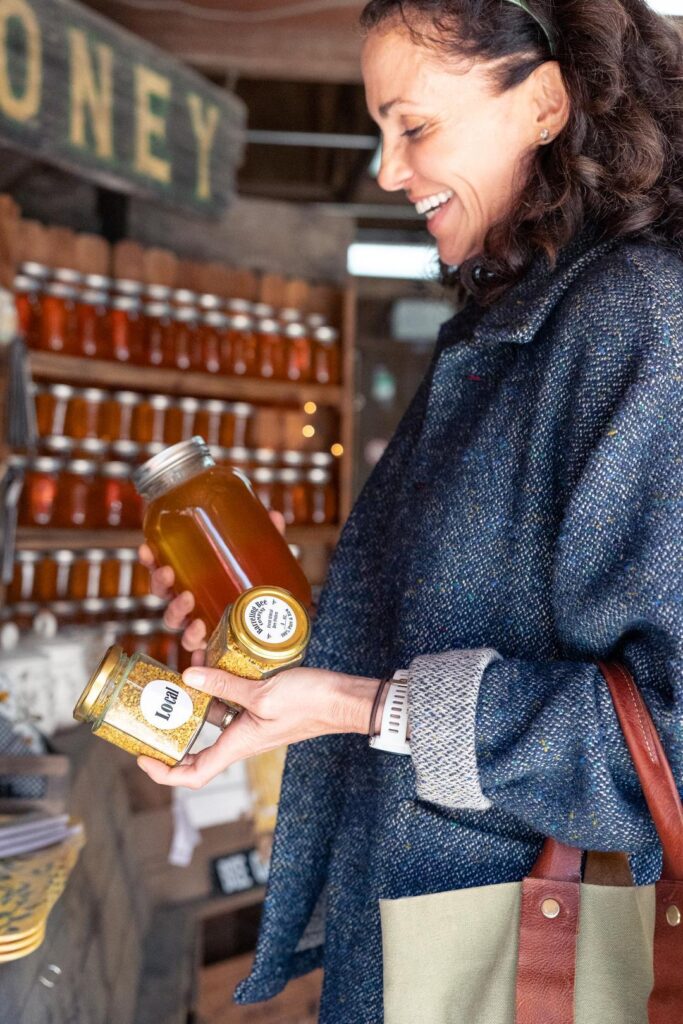 woman holding honey in a jar