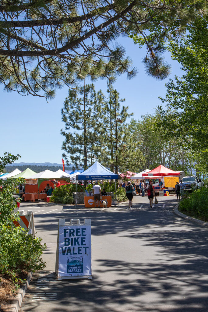 Farmers market tents in a parking lot