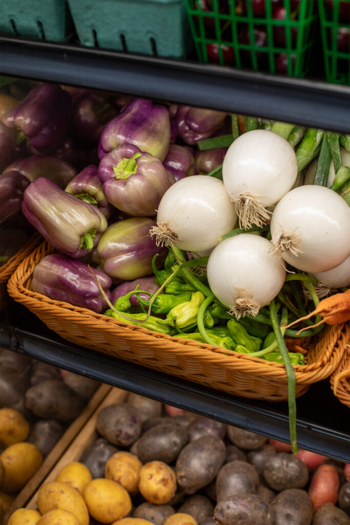 Woven basket with peppers and onions