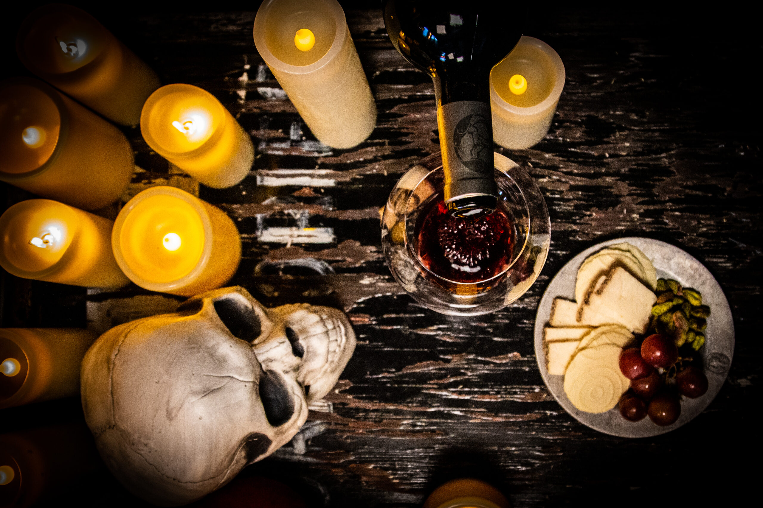 Haunted Wineries cover image - Red wine with a skull and candles