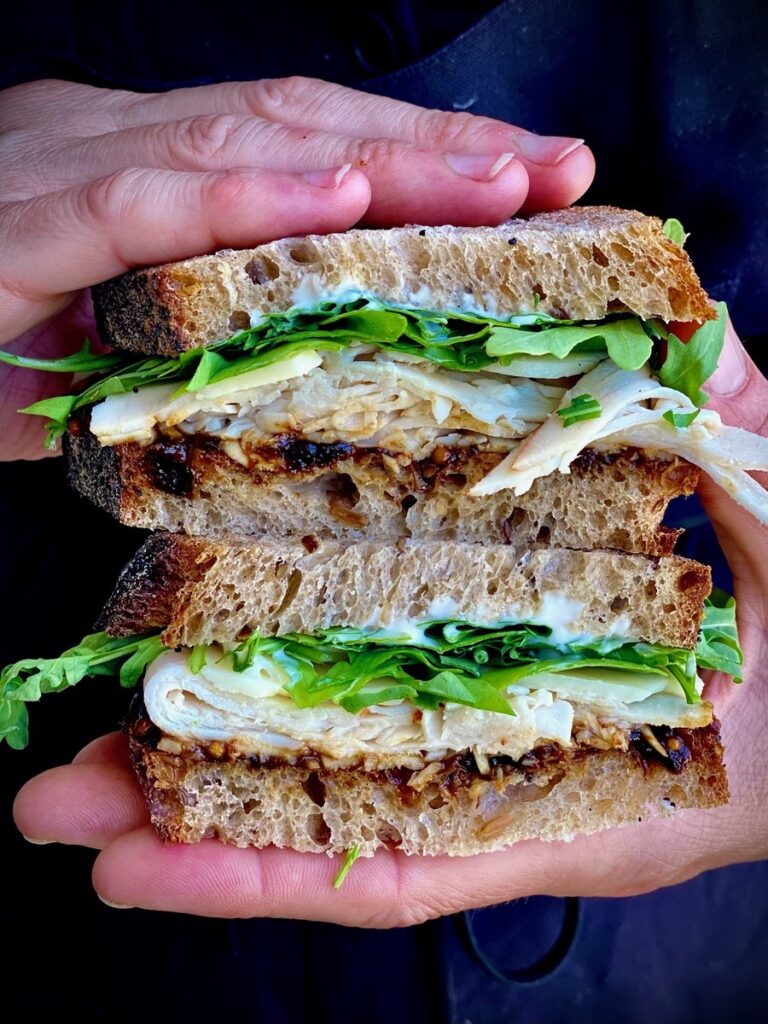 woman holding sandwich