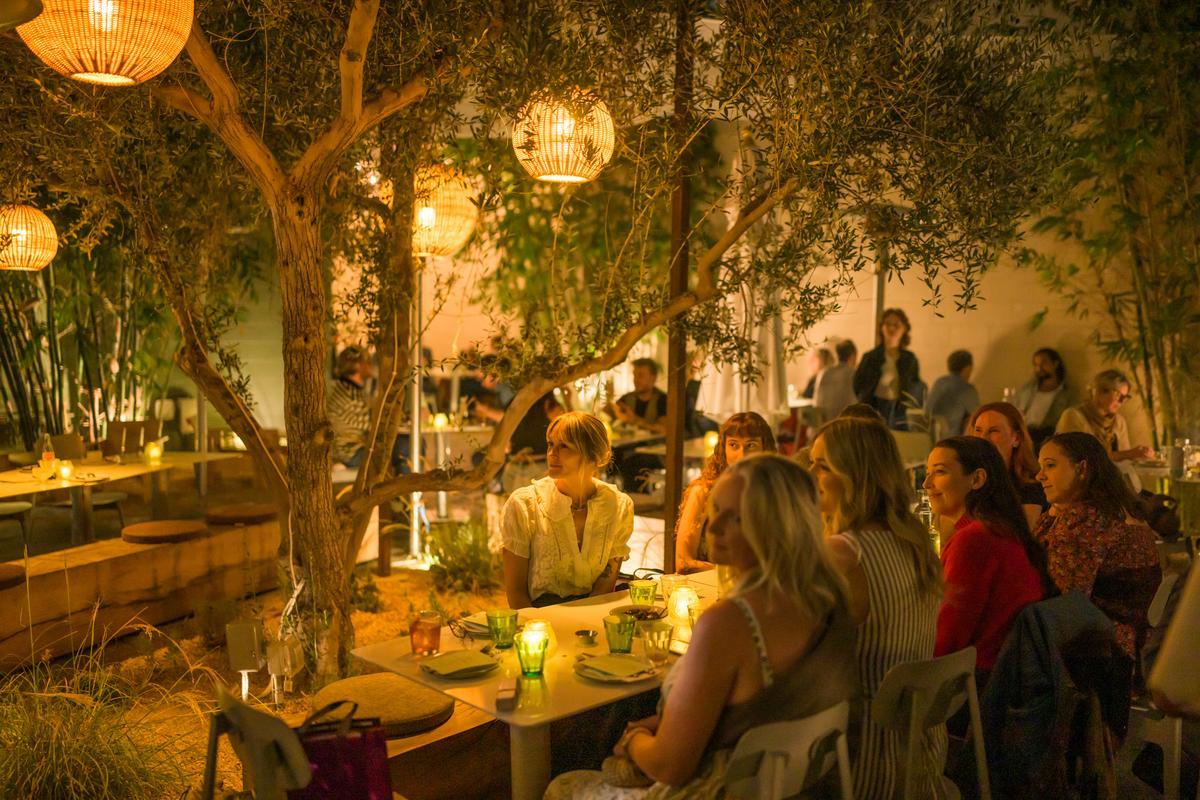 people in a softly lit patio restaurant