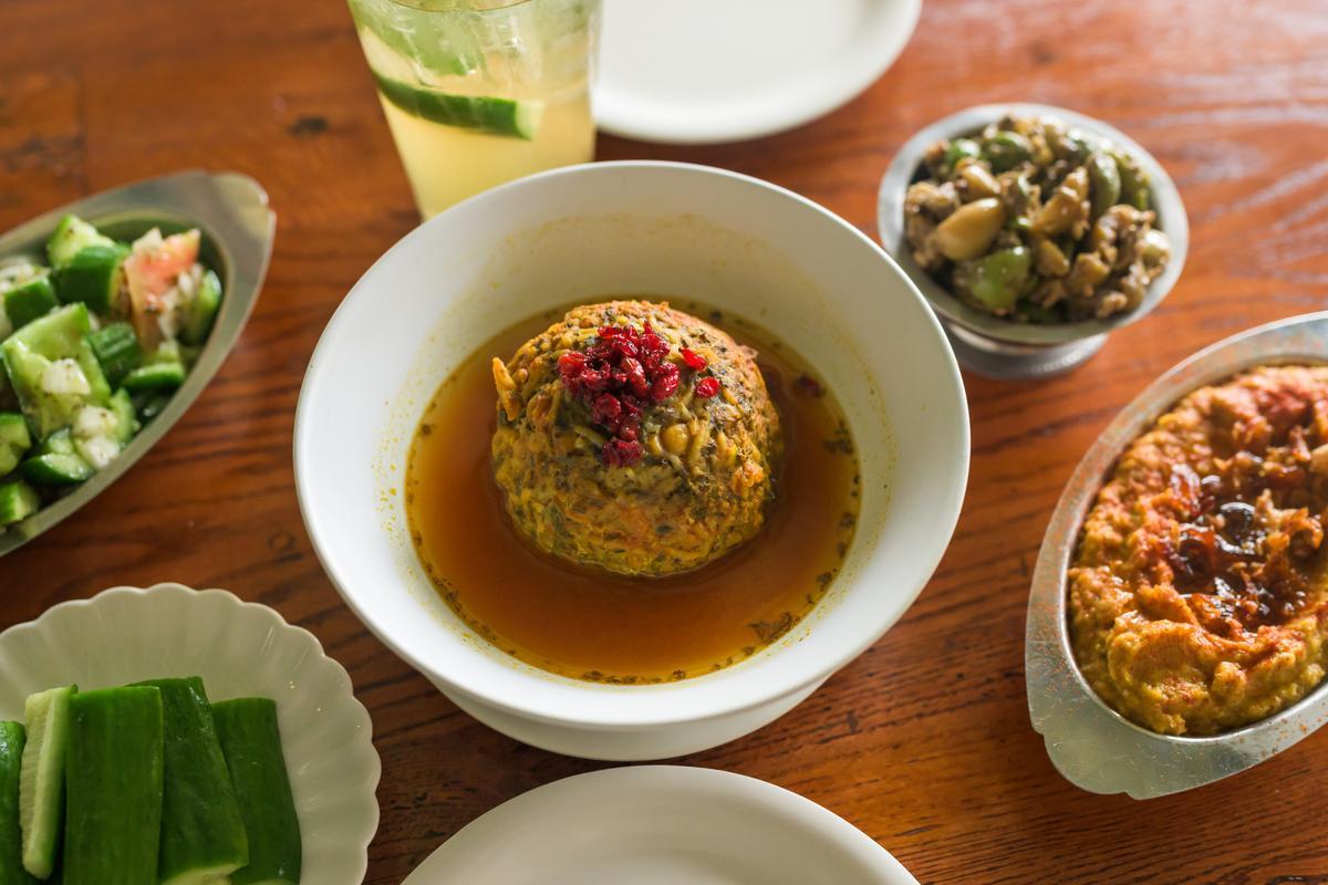 meatball in broth on white plate