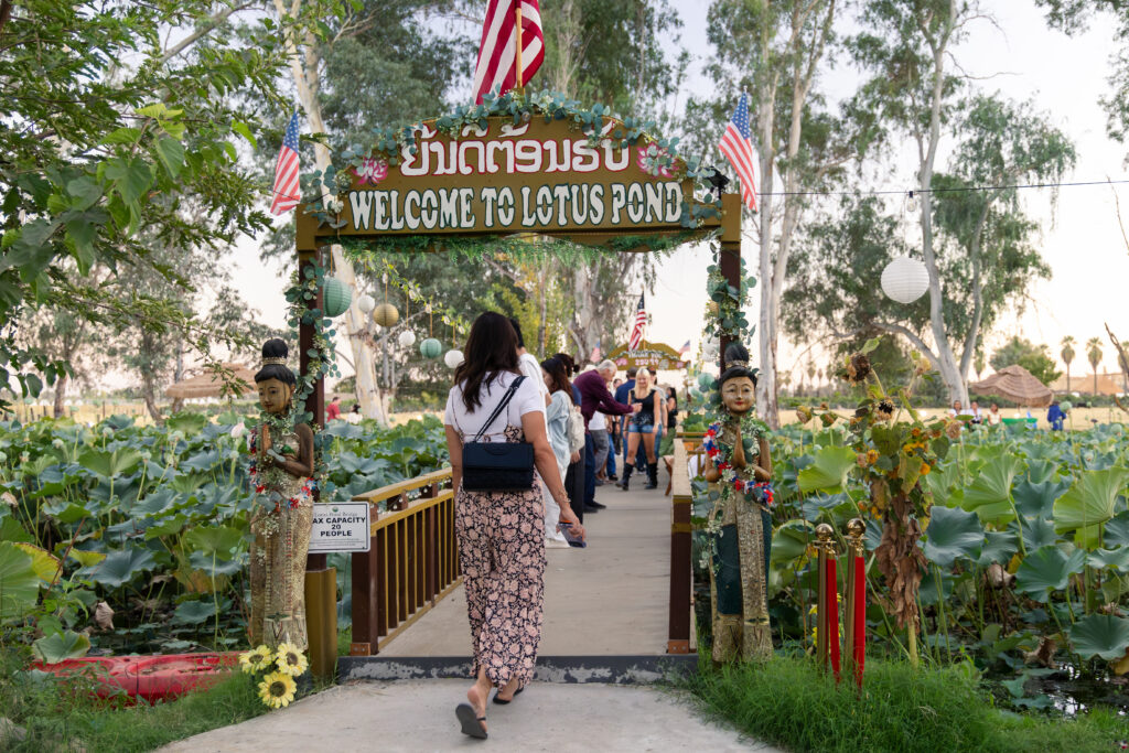 woman walking onto the bridge at Lotus Pond Sanger