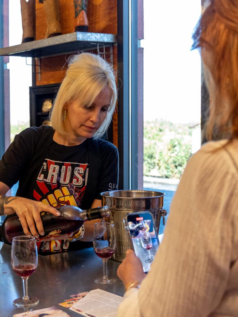 woman enjoying a wine tasting at Quady winery