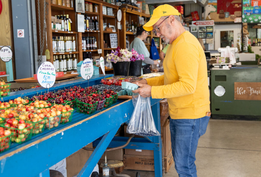 man shopping for fresh produce at the Fruit Bowl 