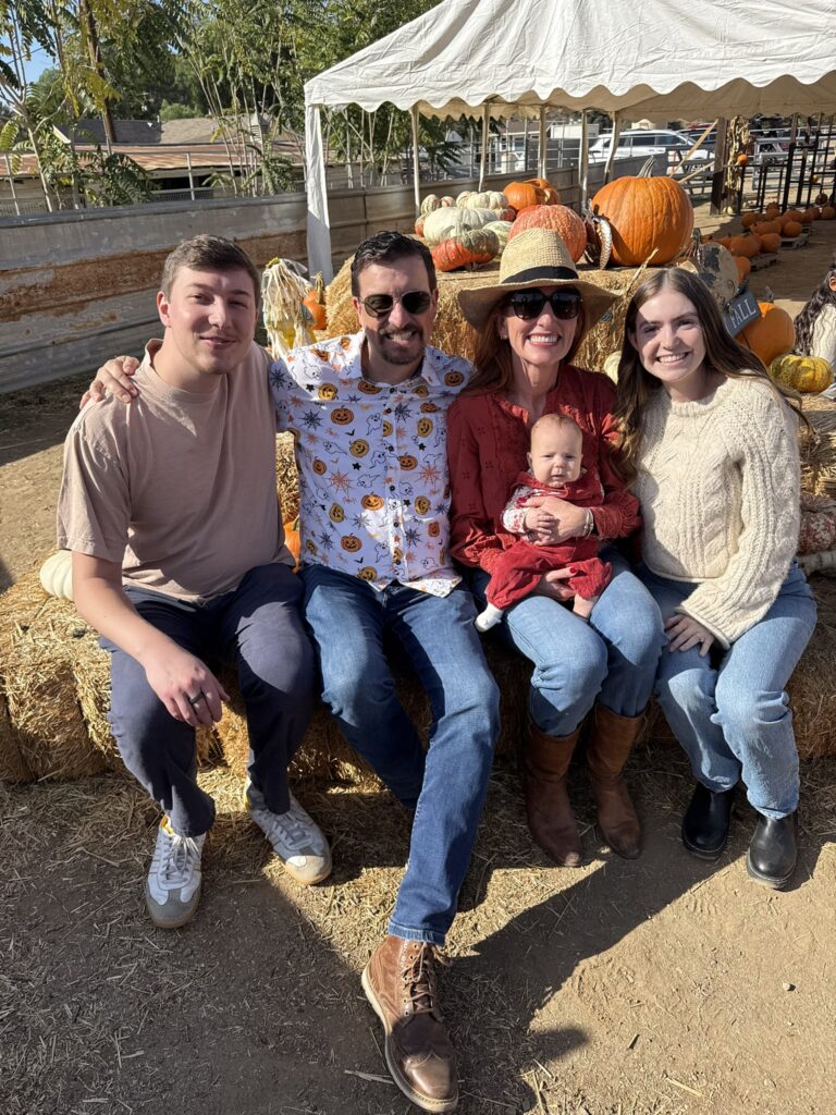 family posing on hay bales at gilchrist ranch