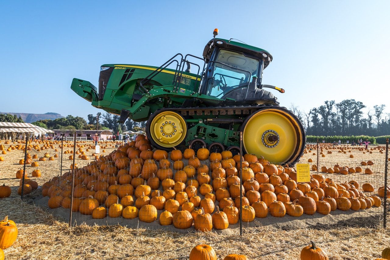 tractor on a hill of pumpkins